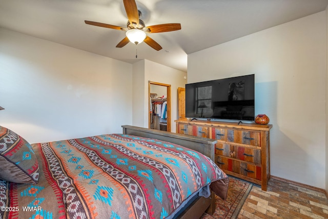 bedroom featuring a closet, a spacious closet, and a ceiling fan