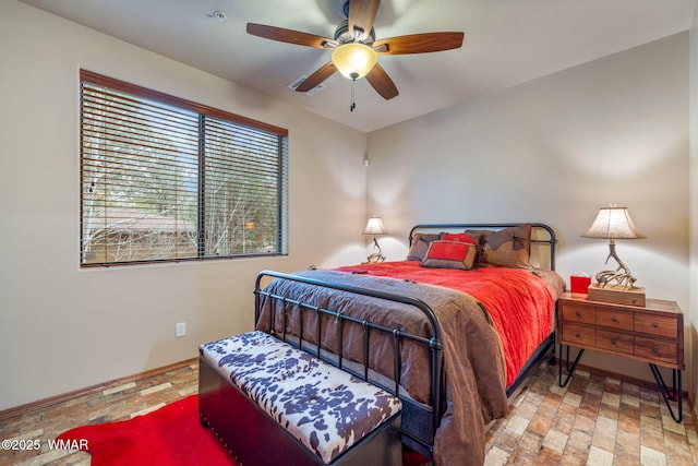 bedroom featuring baseboards and a ceiling fan