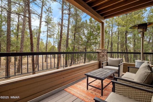 wooden terrace with an outdoor hangout area