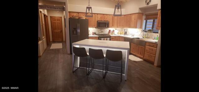 2930 W Lodgepole Ln, Show Low, AZ 85901 - kitchen featuring stainless steel microwave, fridge with ice dispenser, a kitchen island, range, and light countertops