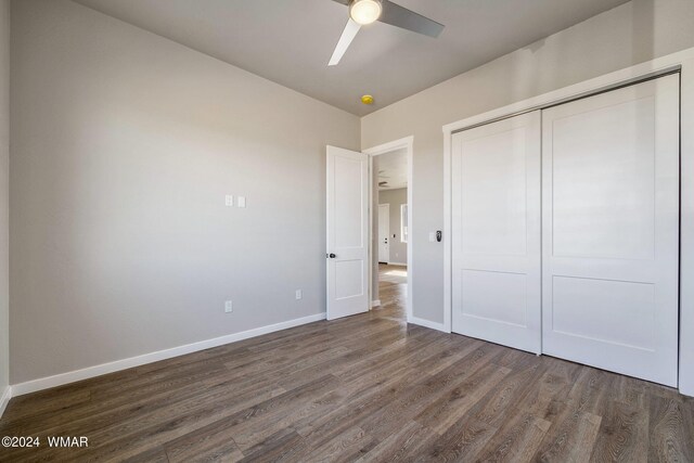 159 Willis St, Taylor, AZ 85939 - unfurnished bedroom featuring dark wood-style floors, a closet, ceiling fan, and baseboards
