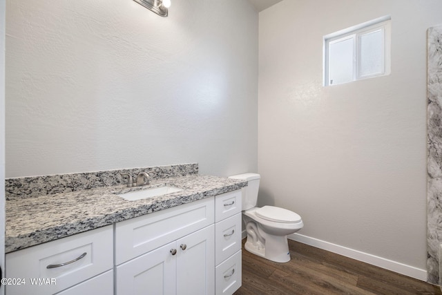 159 Willis St, Taylor, AZ 85939 - bathroom featuring toilet, baseboards, wood finished floors, and vanity