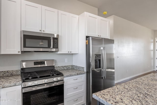 159 Willis St, Taylor, AZ 85939 - kitchen with stainless steel appliances, light stone counters, and white cabinetry