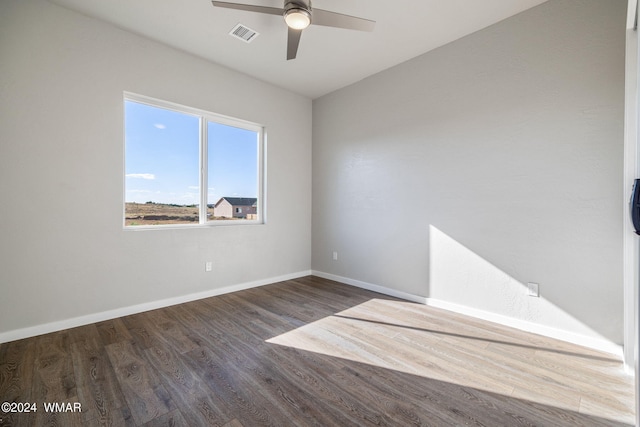 159 Willis St, Taylor, AZ 85939 - spare room with baseboards, visible vents, ceiling fan, and dark wood-style flooring
