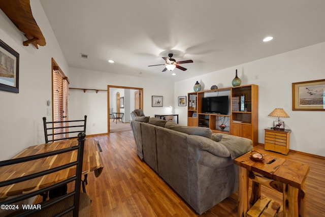 living area with a ceiling fan, visible vents, wood finished floors, and recessed lighting