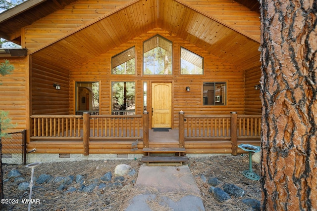 exterior space with covered porch, crawl space, and faux log siding