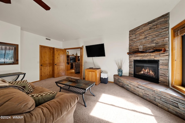 carpeted living room featuring a fireplace and visible vents