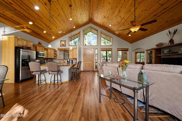 living area with recessed lighting, light wood-style floors, a ceiling fan, wood ceiling, and high vaulted ceiling