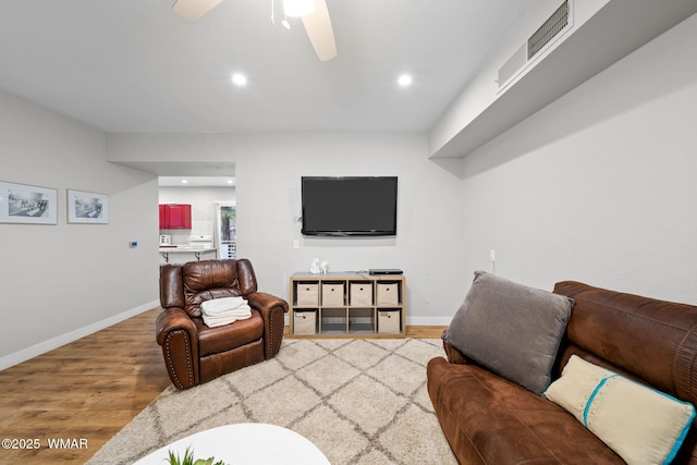 living area with baseboards, recessed lighting, light wood-style flooring, and a ceiling fan