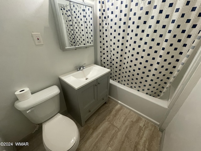 full bathroom featuring shower / bath combination with curtain, vanity, toilet, and wood finished floors