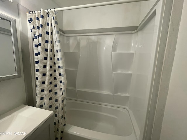 bathroom featuring shower / bath combo and vanity