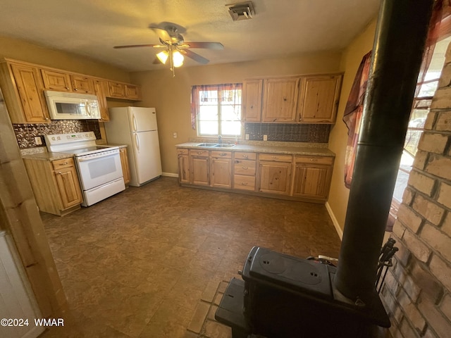 kitchen with white appliances, visible vents, ceiling fan, light countertops, and a sink