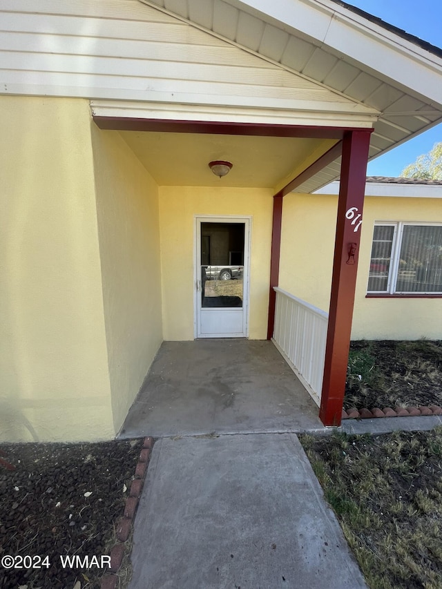 property entrance with stucco siding