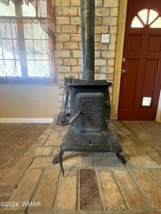 interior details featuring a wood stove and baseboards