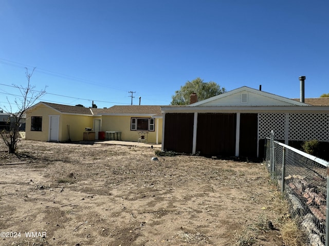 back of property featuring fence