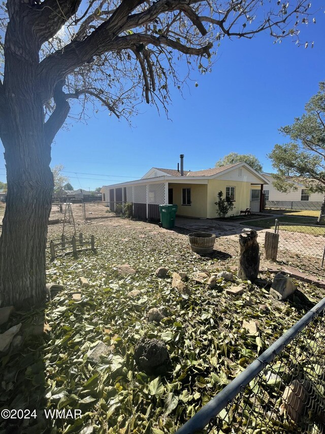 view of side of property featuring fence