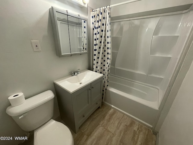 full bath with vanity, wood finished floors, shower / bath combination with curtain, and toilet