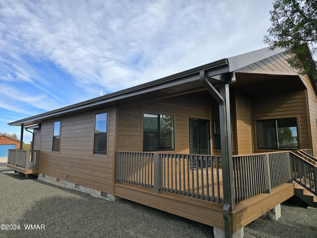 view of side of home featuring crawl space