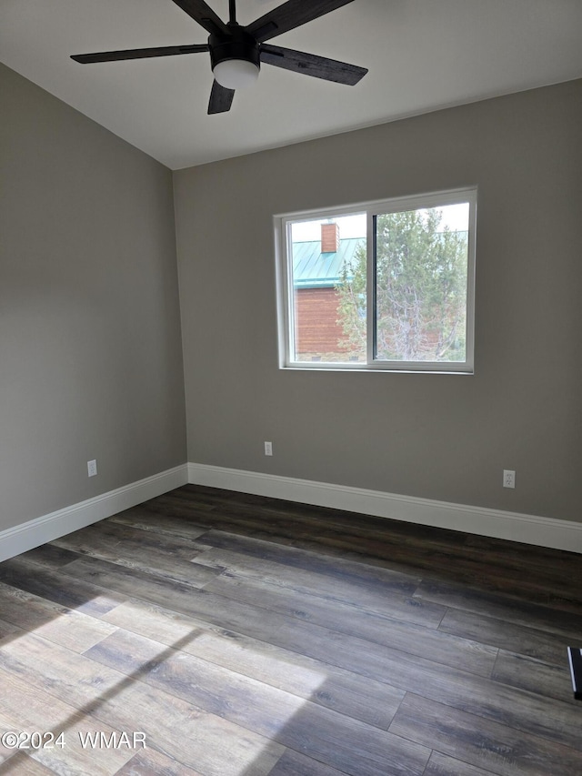 empty room featuring ceiling fan, wood finished floors, and baseboards