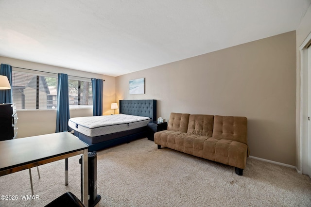 bedroom featuring carpet and baseboards