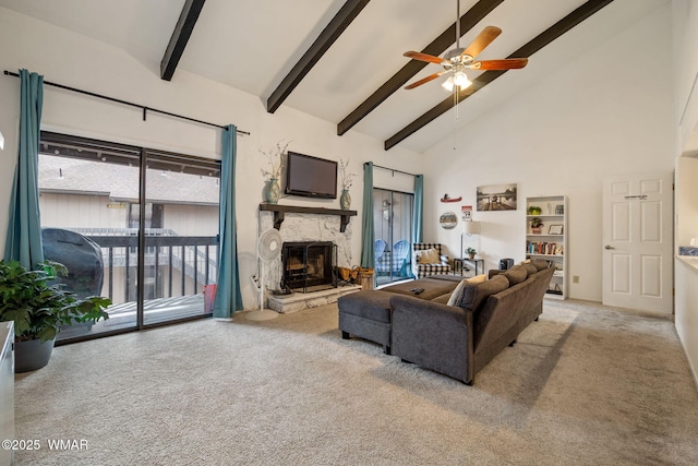 living area featuring a ceiling fan, beamed ceiling, carpet, a stone fireplace, and high vaulted ceiling