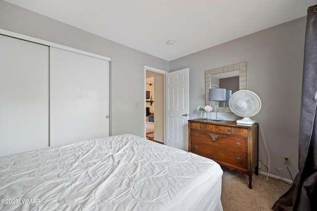 bedroom with a closet, carpet flooring, and baseboards