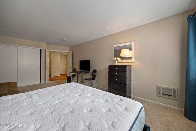 carpeted bedroom with visible vents, baseboards, and a closet