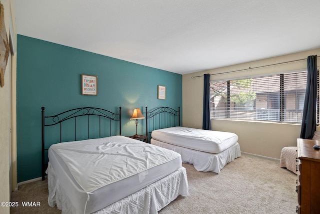 carpeted bedroom featuring baseboards