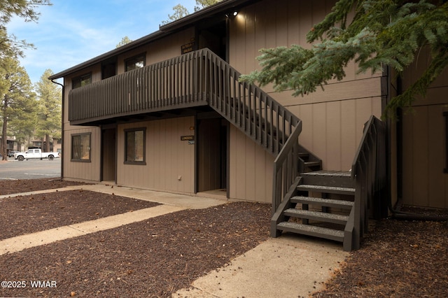 rear view of property with stairs