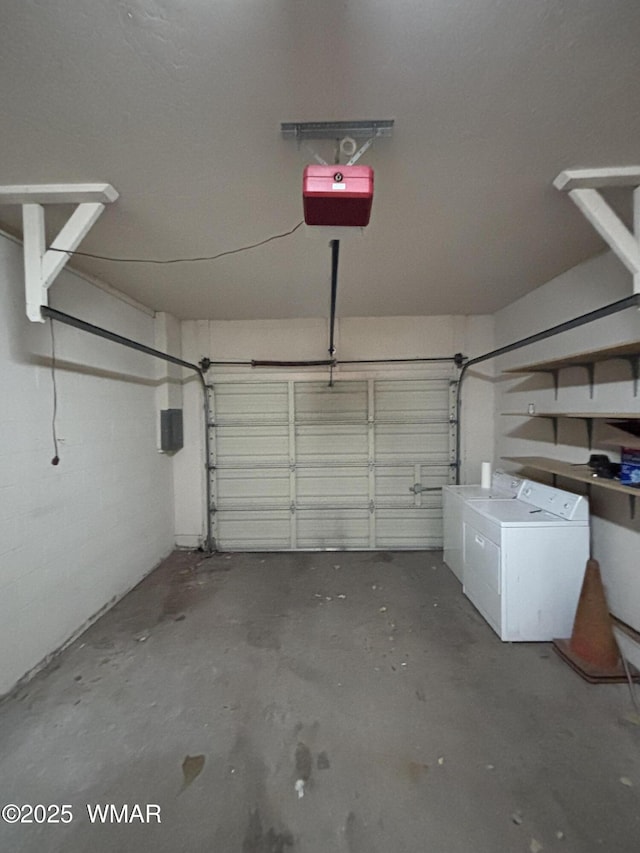 garage featuring washer and dryer and a garage door opener