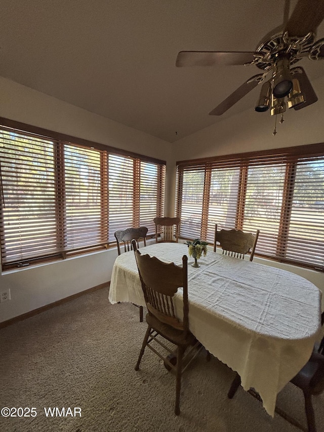 dining space featuring vaulted ceiling, a ceiling fan, baseboards, and carpet floors