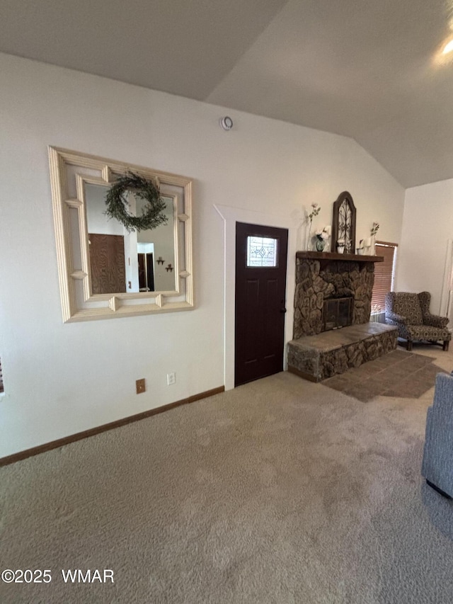 unfurnished living room with baseboards, lofted ceiling, carpet, and a fireplace