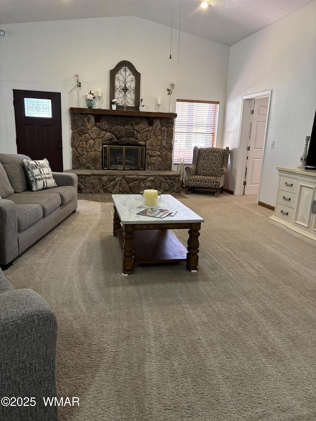 carpeted living area with high vaulted ceiling and a stone fireplace