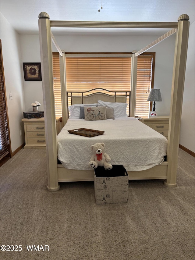 bedroom featuring baseboards and carpet