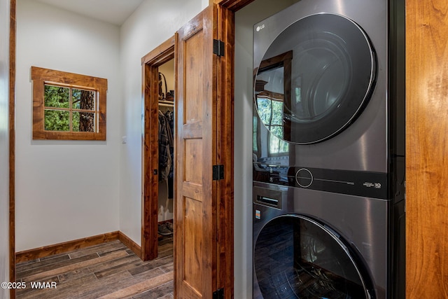 3 County Road 1058, Greer, AZ 85927 - washroom featuring stacked washer and clothes dryer, wood finished floors, baseboards, and healthy amount of natural light