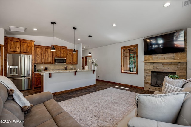 3 County Road 1058, Greer, AZ 85927 - living room featuring vaulted ceiling, baseboards, dark wood-style floors, recessed lighting, and a stone fireplace