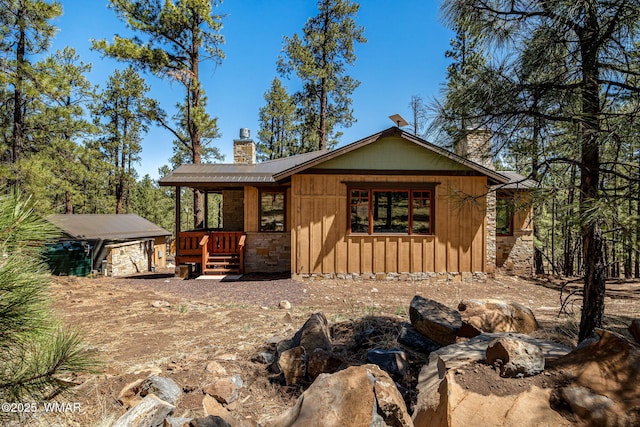 3 County Road 1058, Greer, AZ 85927 - view of front facade featuring a chimney and a detached garage