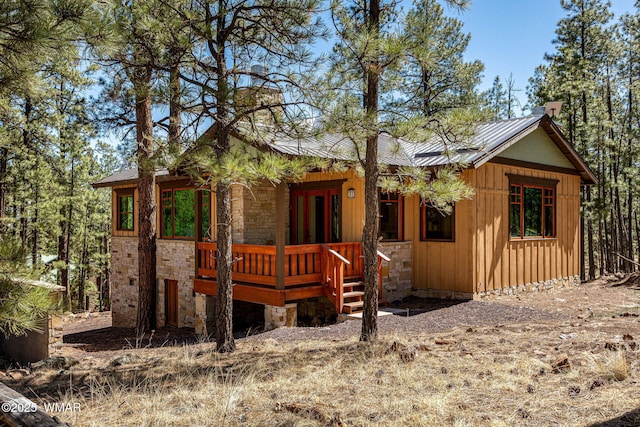 3 County Road 1058, Greer, AZ 85927 - chalet / cabin with metal roof, stone siding, a porch, and board and batten siding