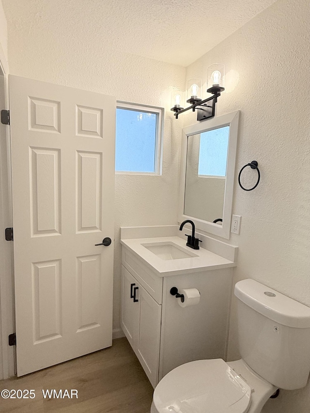 412 W 8th St S, Snowflake, AZ 85937 - bathroom featuring a textured wall, vanity, toilet, wood finished floors, and a textured ceiling
