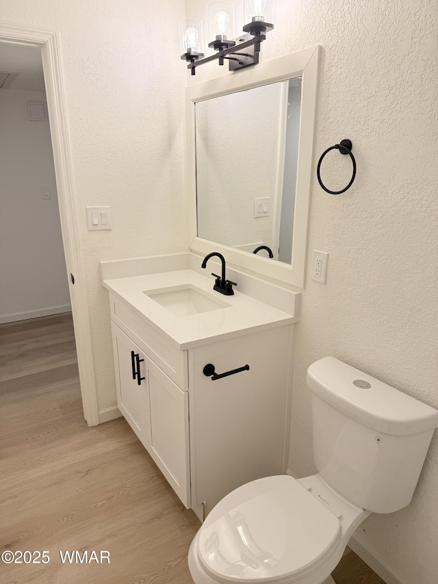 412 W 8th St S, Snowflake, AZ 85937 - bathroom featuring vanity, wood finished floors, toilet, a chandelier, and a textured wall