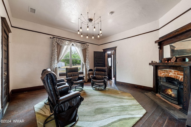 living room featuring a textured wall, visible vents, baseboards, a brick fireplace, and dark wood-style floors