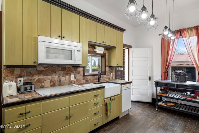 kitchen featuring white appliances, decorative backsplash, dark wood finished floors, hanging light fixtures, and a sink