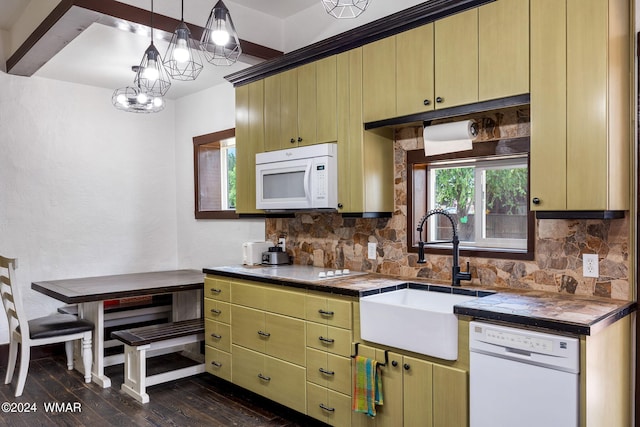 kitchen with white appliances, dark wood-style flooring, a sink, tasteful backsplash, and decorative light fixtures