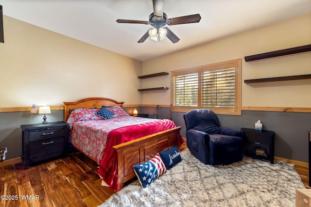 bedroom with ceiling fan, baseboards, and wood finished floors