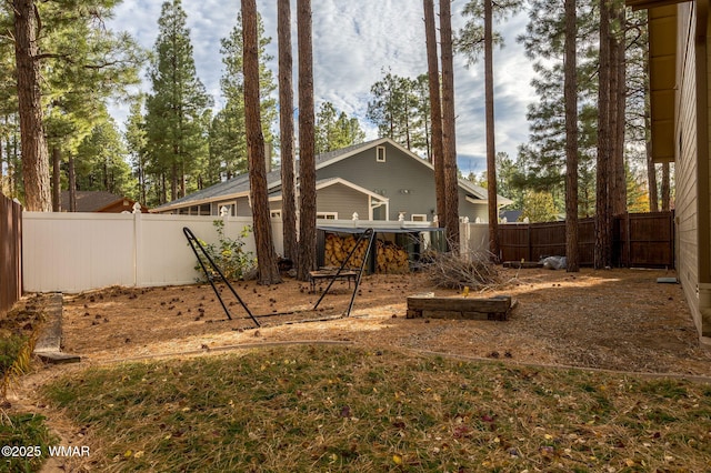 back of house with a fenced backyard