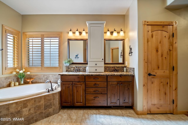 full bathroom with a garden tub, double vanity, and a sink