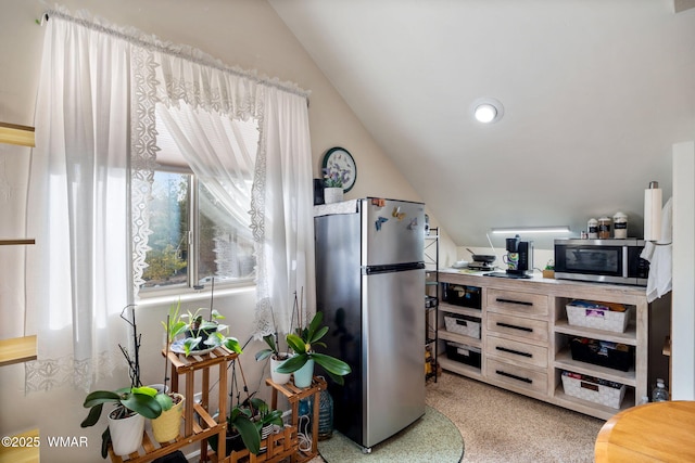 interior space with stainless steel appliances and lofted ceiling