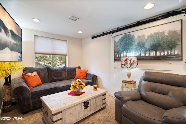 living area featuring carpet, a barn door, recessed lighting, and visible vents