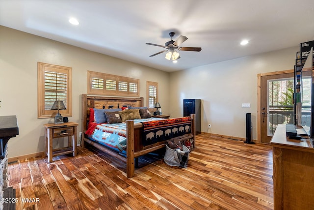 bedroom featuring access to exterior, recessed lighting, wood finished floors, and baseboards