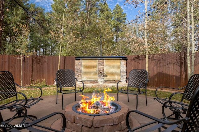 view of patio / terrace featuring a fire pit and fence